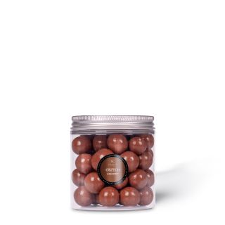 Hazelnut in milk chocolate in a jar